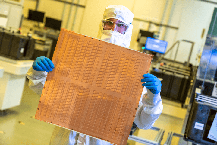 an engineer from Intel is seen with a test panel made of glass core substrat